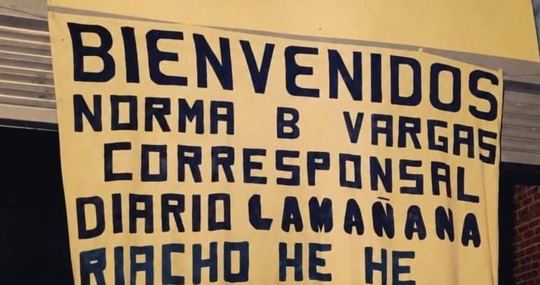 Handmade yellow banner: Welcome Norma B Vargas correspondent Diario La Mañana Riacho He Hé.